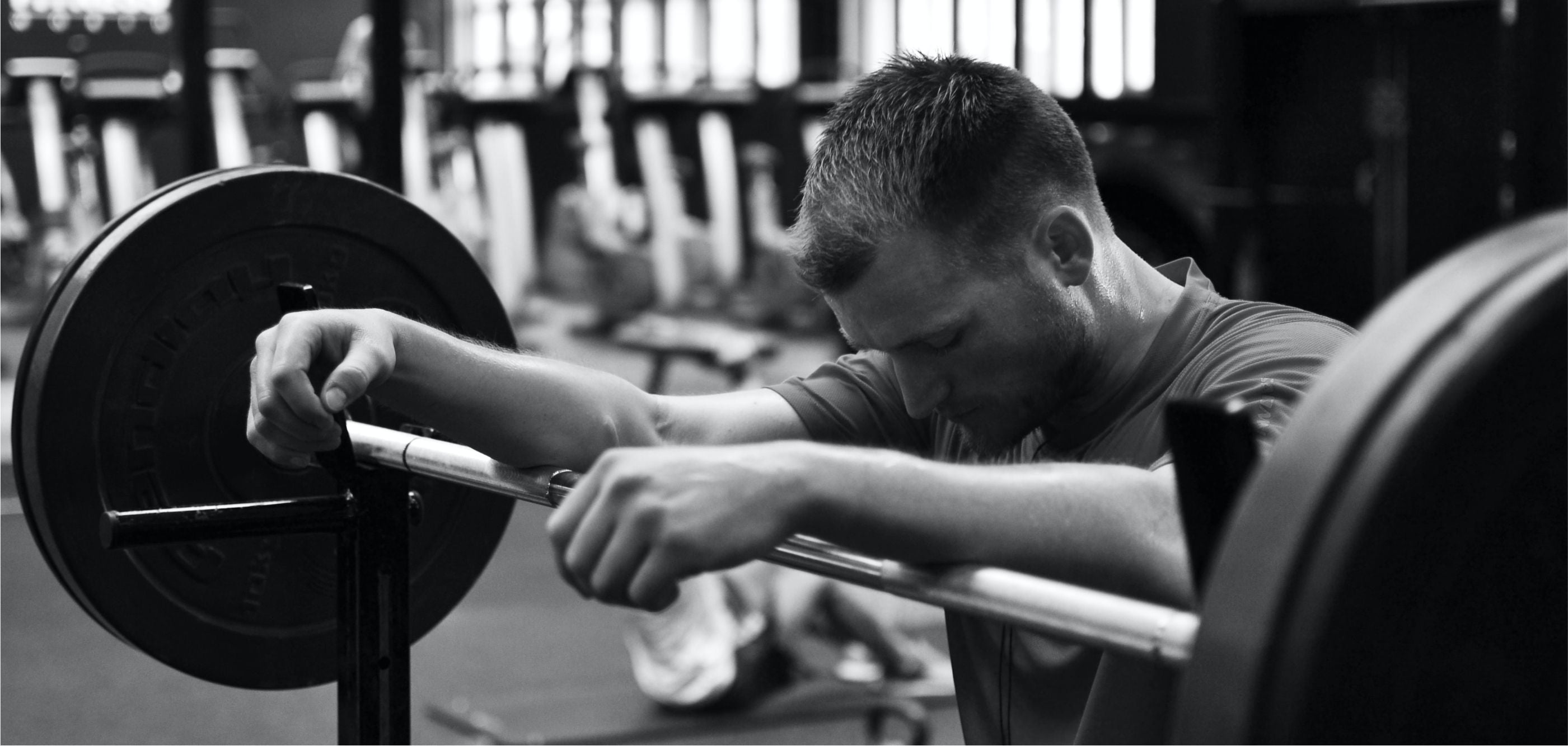 A man performing squats during leg day at the gym, focusing on his lower body strength and fitness.